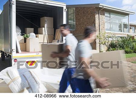 Movers carrying cardboard boxes in driveway View Large Photo Image Stock Photograph - Movers carrying cardboard boxes in driveway. Fotosearch