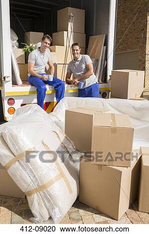 Movers sitting in moving van in driveway View Large Photo Image Stock Image - Movers sitting in moving van in driveway. Fotosearch