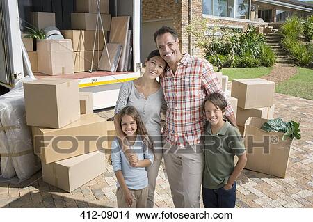 Portrait of smiling family standing near moving van in driveway View Large Photo Image Picture - Portrait of smiling family standing near moving van in driveway. Fotosearch