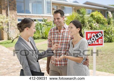 Realtor giving couple keys to new house View Large Photo Image Stock Image - Realtor giving couple keys to new house. Fotosearch