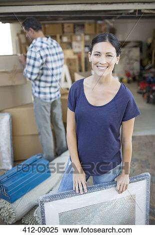 Woman holding picture in driveway among cardboard boxes View Large Photo Image Stock Photography - Woman holding picture in driveway among cardboard boxes. Fotosearch