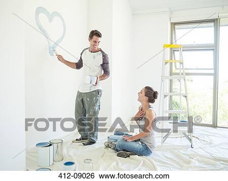 Woman watching man paint blue heart on wall View Large Photo Image Stock Photograph - Woman watching man paint blue heart on wall. Fotosearch