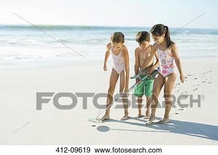 Children using metal detector on beach View Large Photo Image Stock Photo - Children using metal detector on beach. Fotosearch