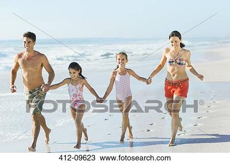 Family holding hands and running on beach View Large Photo Image Stock Image - Family holding hands and running on beach. Fotosearch