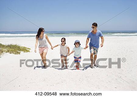 Family holding hands and walking on beach View Large Photo Image Stock Photo - Family holding hands and walking on beach. Fotosearch