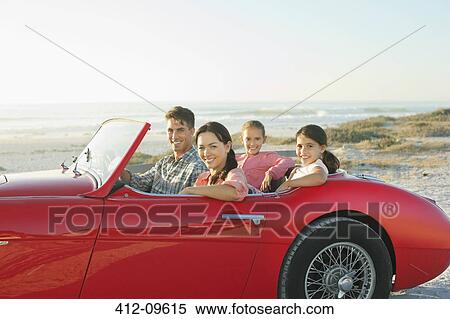 Stock Photography - Family in convertible at beach. Fotosearch