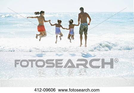 Family jumping in surf at beach View Large Photo Image Stock Photograph - Family jumping in surf at beach. Fotosearch