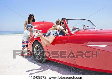 Family packing convertible on beach View Large Photo Image Stock Image - Family packing convertible on beach. Fotosearch