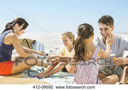 Family relaxing on beach View Large Photo Image Stock Image - Family relaxing on beach. Fotosearch