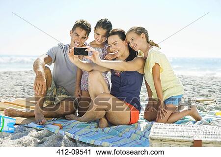 Family taking self-portrait at beach View Large Photo Image Stock Image - Family taking self-portrait at beach. Fotosearch