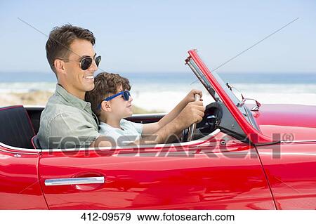 Father and son driving convertible at beach View Large Photo Image Stock Photo - Father and son driving convertible at beach. Fotosearch