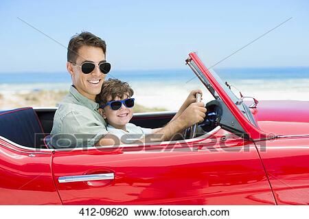 Father and son driving convertible on beach View Large Photo Image Stock Image - Father and son driving convertible on beach. Fotosearch