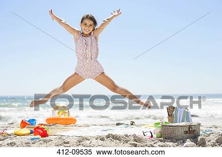 Girl jumping on beach View Large Photo Image Stock Photography - Girl jumping on beach. Fotosearch