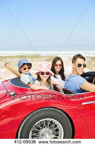Portrait of smiling family in convertible at beach View Large Photo Image Stock Photograph - Portrait of smiling family in convertible at beach. Fotosearch