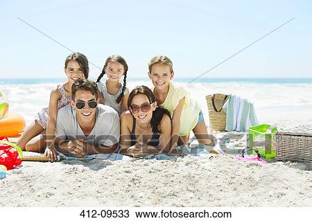 Portrait of smiling family on beach View Large Photo Image Stock Image - Portrait of smiling family on beach. Fotosearch