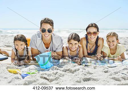 Portrait of smiling family on beach View Large Photo Image Stock Photo - Portrait of smiling family on beach. Fotosearch