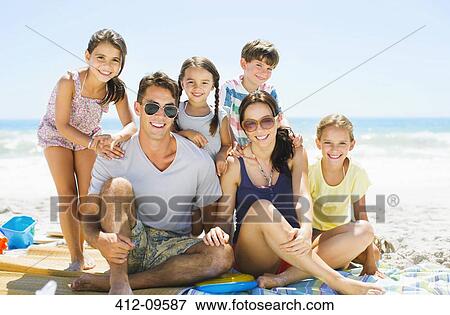 Stock Photo - Portrait of smiling family on beach. Fotosearch