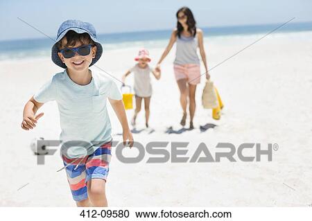 Smiling boy running on beach View Large Photo Image Stock Image - Smiling boy running on beach. Fotosearch