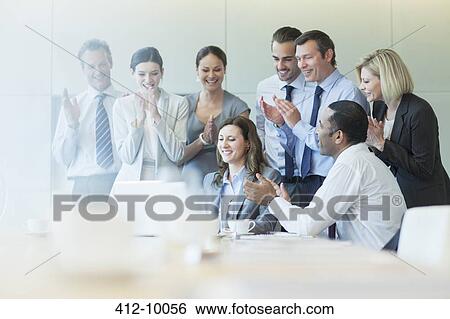 Business people cheering in meeting View Large Photo Image Stock Photograph - Business people cheering in meeting. Fotosearch
