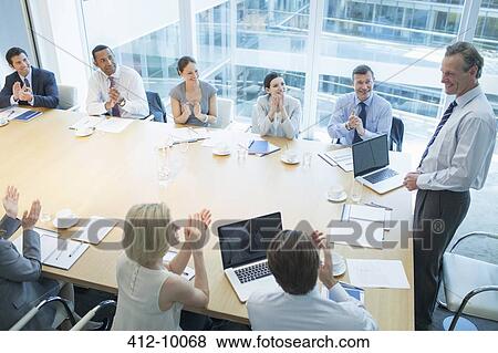 Stock Photo - Business people clapping in meeting. Fotosearch