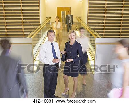 Business people in busy office corridor View Large Photo Image Stock Image - Business people in busy office corridor. Fotosearch