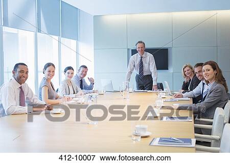 Business people smiling in meeting View Large Photo Image Stock Photo - Business people smiling in meeting. Fotosearch
