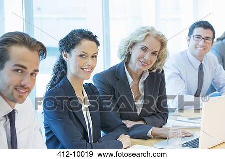 Stock Photo - Business people smiling in meeting. Fotosearch