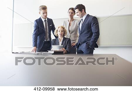 Stock Photo - Business people talking in conference room. Fotosearch