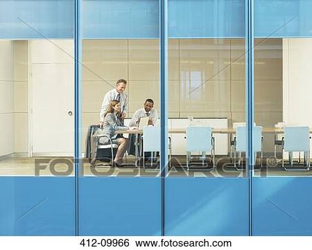 Stock Photograph - Business people talking in conference room. Fotosearch