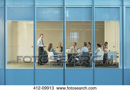 Stock Image - Business people talking in meeting. Fotosearch
