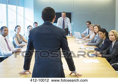 Stock Image - Business people talking in meeting. Fotosearch