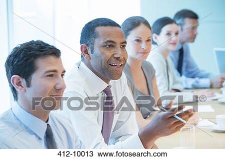 Stock Image - Business people talking in meeting. Fotosearch