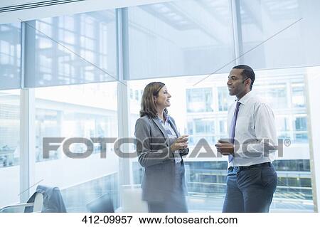 Business people talking in office View Large Photo Image Stock Photo - Business people talking in office. Fotosearch