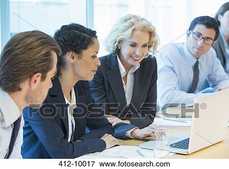 Business people using laptop in meeting View Large Photo Image Stock Photo - Business people using laptop in meeting. Fotosearch