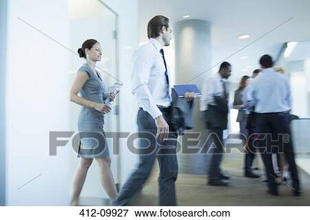 Stock Photo - Business people walking in office. Fotosearch