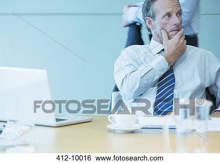 Businessman sitting in meeting View Large Photo Image Stock Photograph - Businessman sitting in meeting. Fotosearch