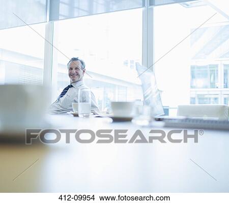 Picture - Businessman smiling in conference room. Fotosearch