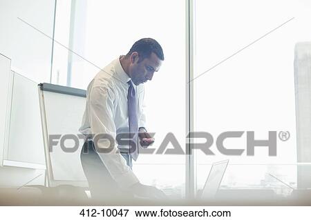Businessman working in office View Large Photo Image Stock Photo - Businessman working in office. Fotosearch
