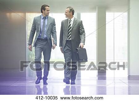 Businessmen talking in office lobby View Large Photo Image Stock Photography - Businessmen talking in office lobby. Fotosearch