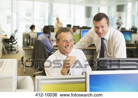 Stock Photograph - Businessmen working in office. Fotosearch