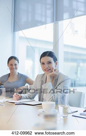 Businesswoman smiling in conference room View Large Photo Image Stock Image - Businesswoman smiling in conference room. Fotosearch