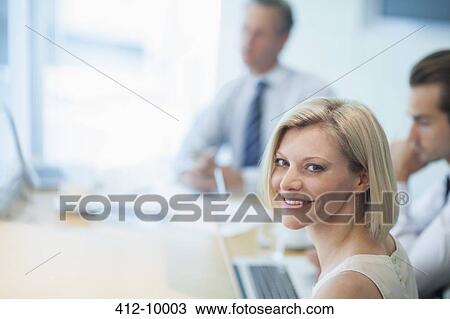 Businesswoman smiling in meeting View Large Photo Image Stock Image - Businesswoman smiling in meeting. Fotosearch