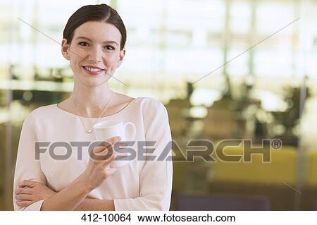 Picture - Businesswoman smiling in office. Fotosearch