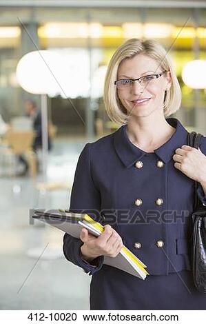 Businesswoman smiling in office View Large Photo Image Stock Image - Businesswoman smiling in office. Fotosearch