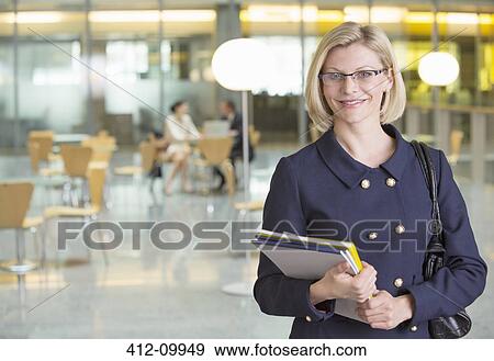 Businesswoman smiling in office View Large Photo Image Stock Photo - Businesswoman smiling in office. Fotosearch