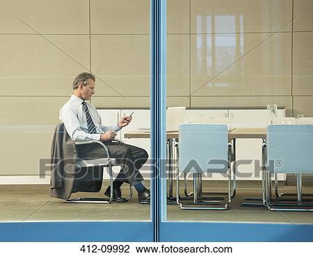 Businesswoman working at conference table View Large Photo Image Stock Image - Businesswoman working at conference table. Fotosearch