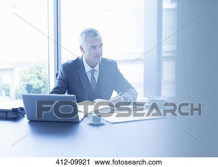 Businesswoman working at desk in office View Large Photo Image Stock Image - Businesswoman working at desk in office. Fotosearch