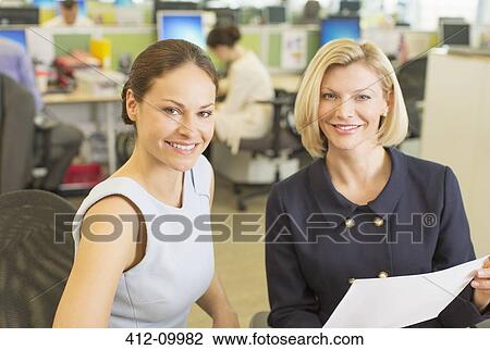 Businesswomen talking in office View Large Photo Image Stock Image - Businesswomen talking in office. Fotosearch