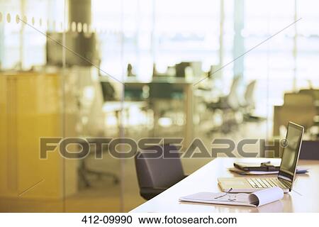 Laptop on desk in office View Large Photo Image Stock Image - Laptop on desk in office. Fotosearch