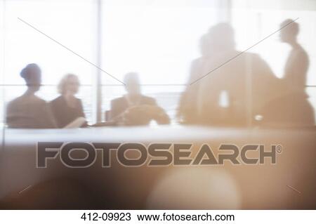 Stock Image - Silhouette of business people in meeting. Fotosearch